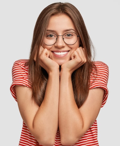 A woman in the glasses is happily smiling