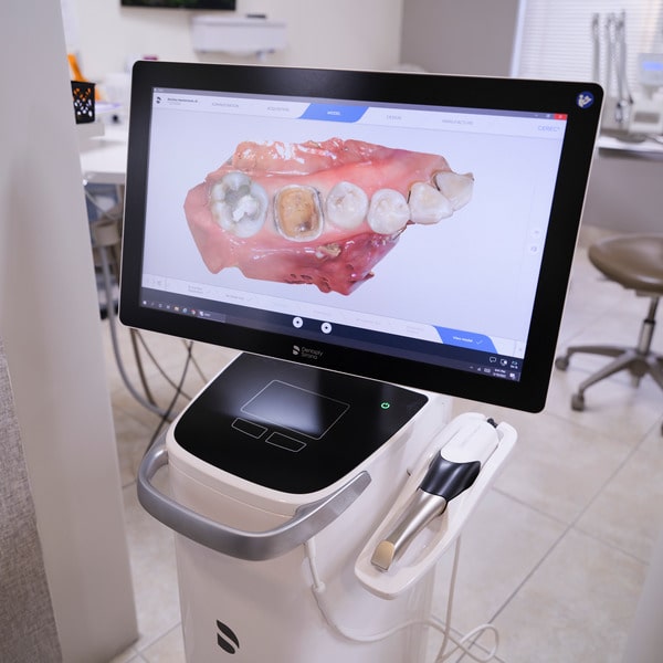 Dental tech wide monitor with dental utensils on it